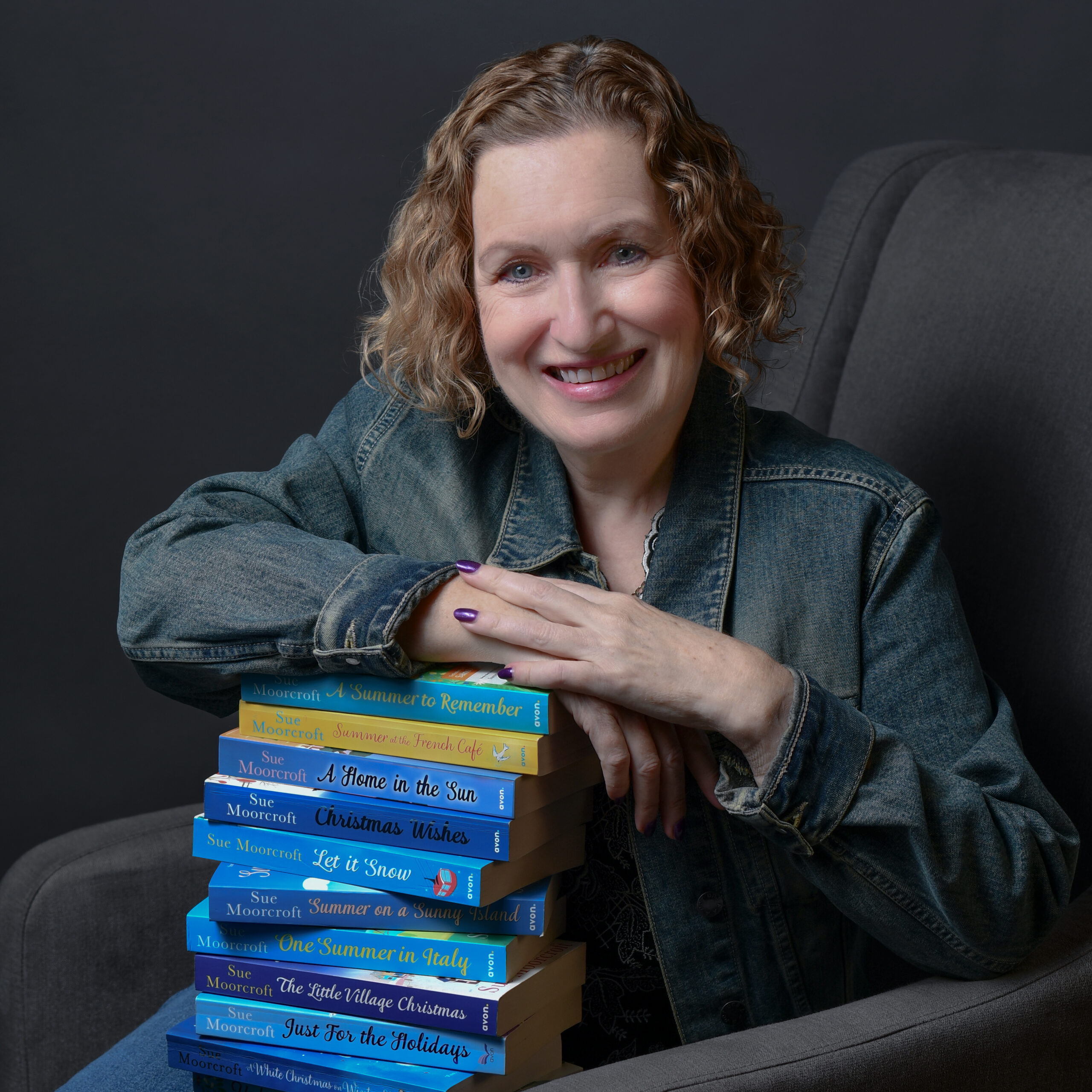 Image shows Sue Moorcroft with books